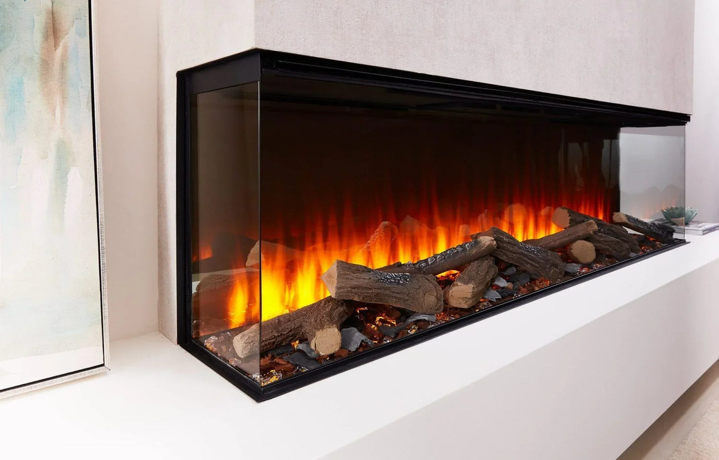 Modern electric fireplace with realistic log display and glass sides in a white wall unit