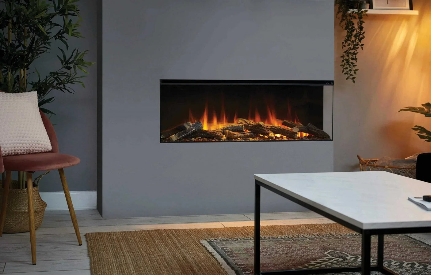 Modern electric fireplace with realistic log display in a grey living room setting