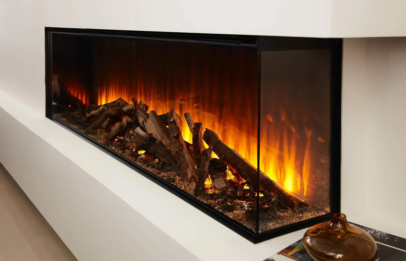 Modern electric fireplace with realistic log effect and glass front on white wall