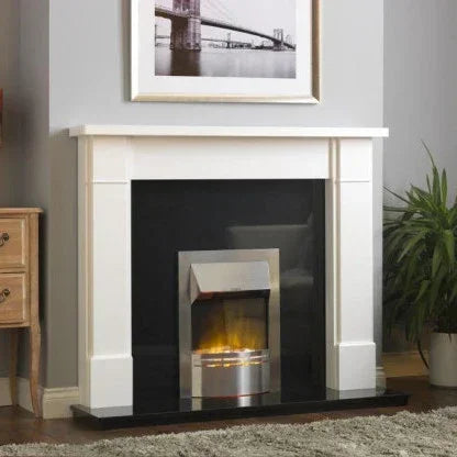 Inset electric fire with chrome trim set in black and white fireplace, living room setting