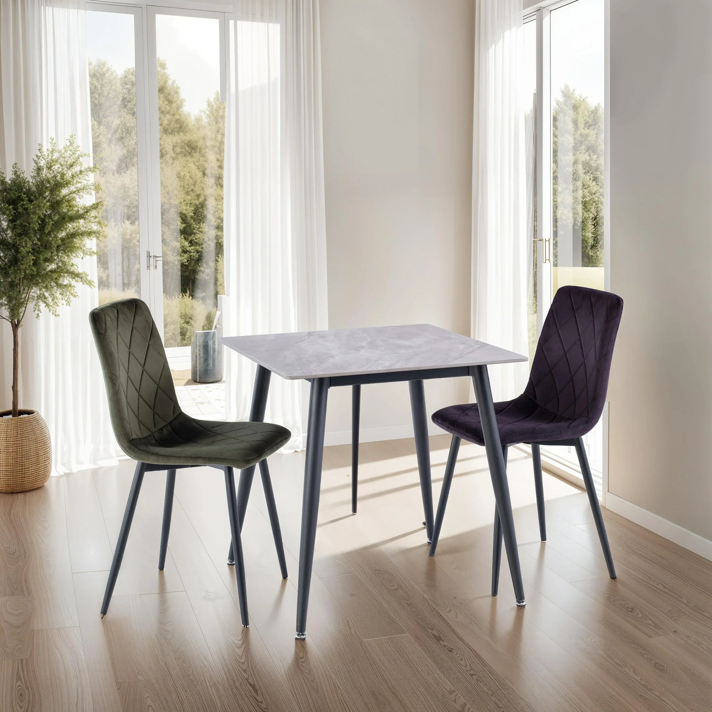 Square marble dining table with two velvet chairs in light-filled modern dining room