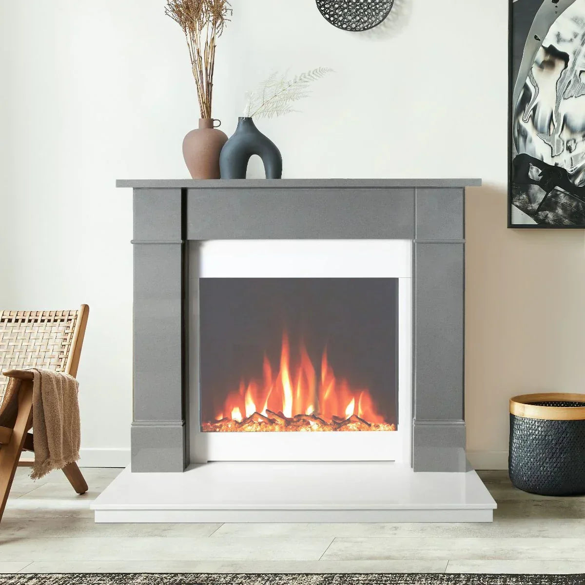 Modern electric fireplace suite with grey surround and decorative vases in living room setting