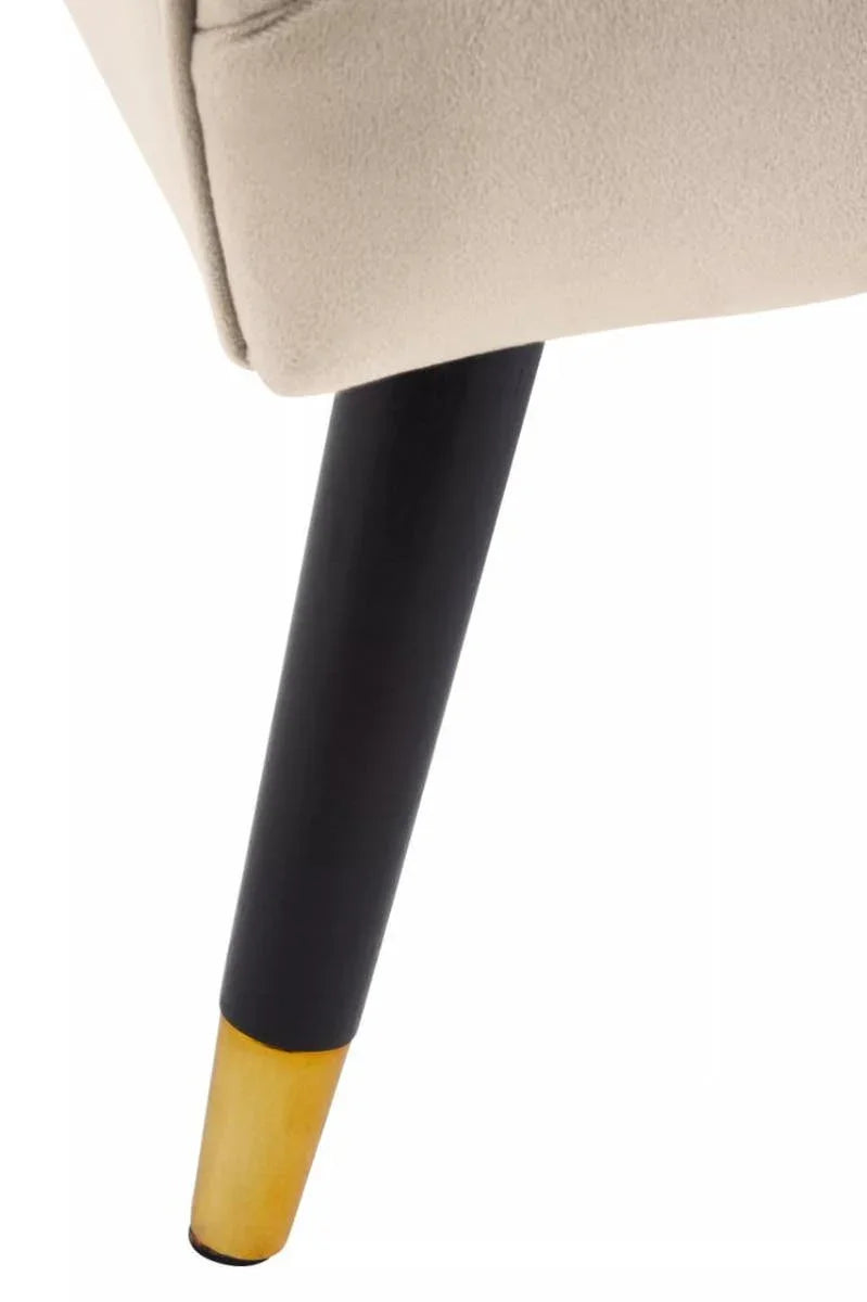 Closeup of velvet chair leg with black and natural wood finish