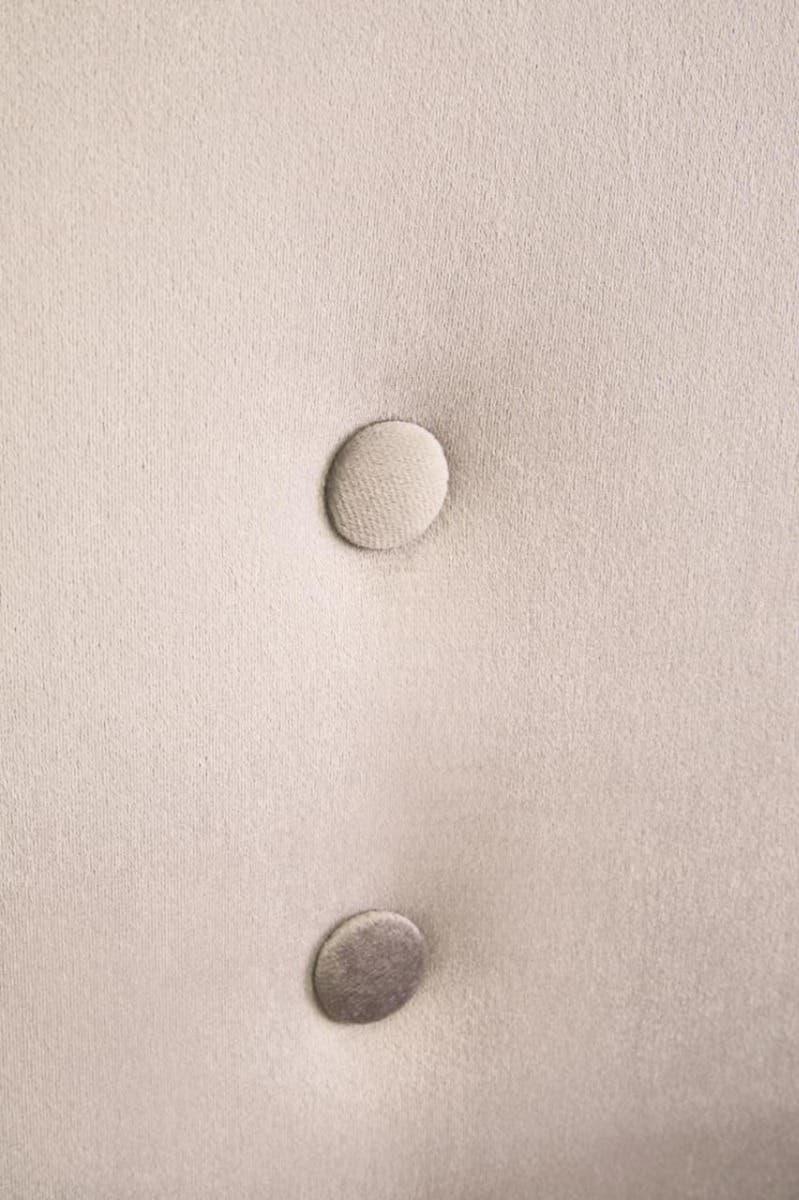 Stone velvet chair button detail close-up with soft textured upholstery