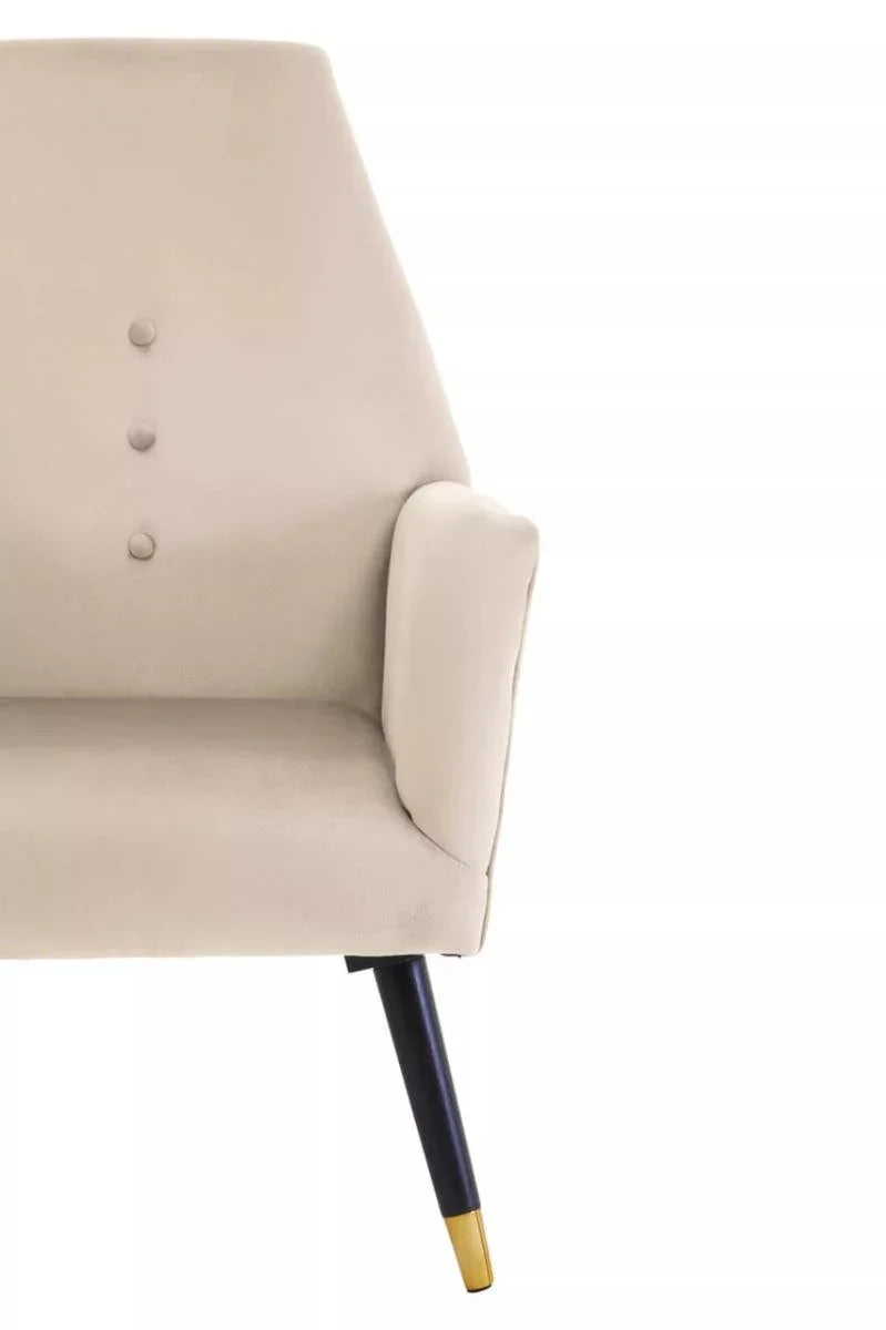 Stone velvet accent chair with button detail and gold tipped black wooden leg, side view