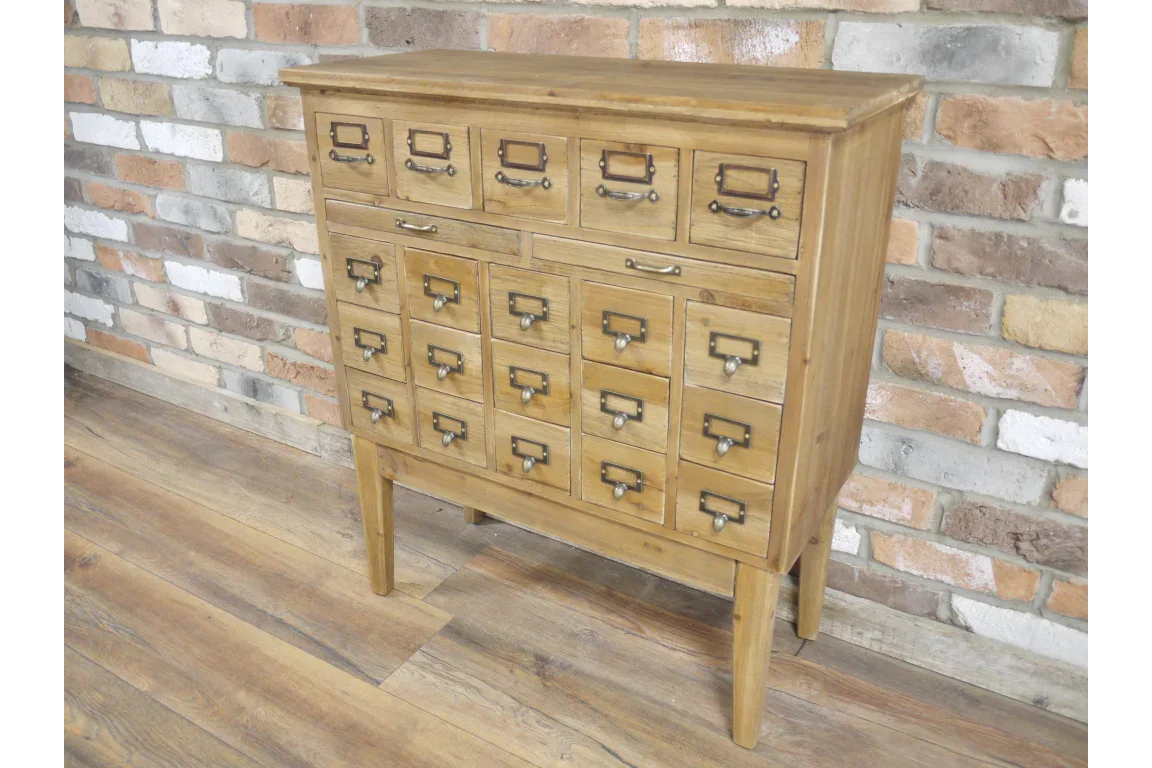 Rustic wooden storage cabinet with multiple drawers and metal handles against brick wall
