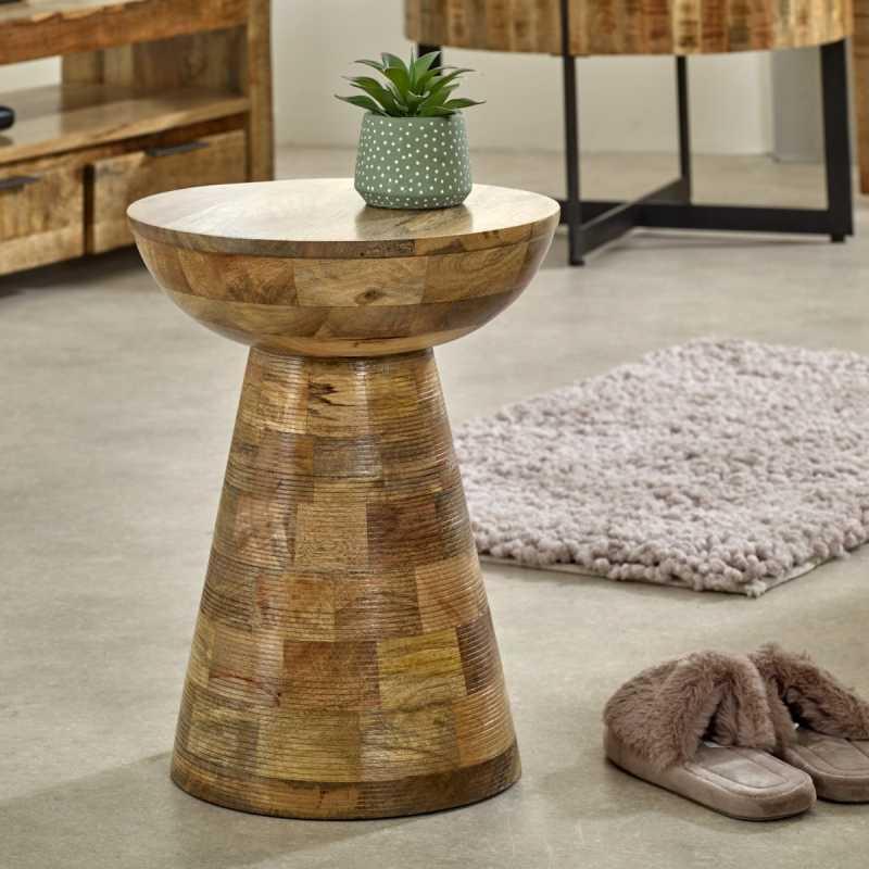 Mango wood side table with natural finish and houseplant in modern living room setting