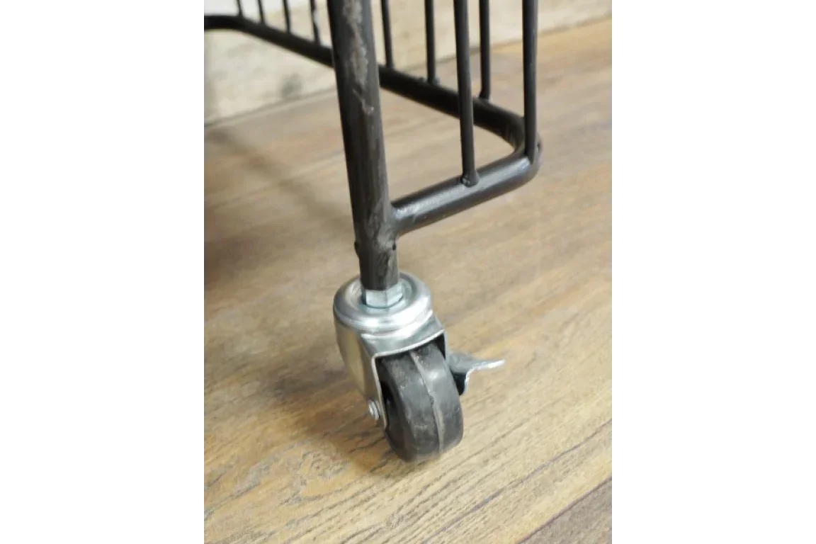 Metal furniture leg with swivel caster wheel and brake on wood floor