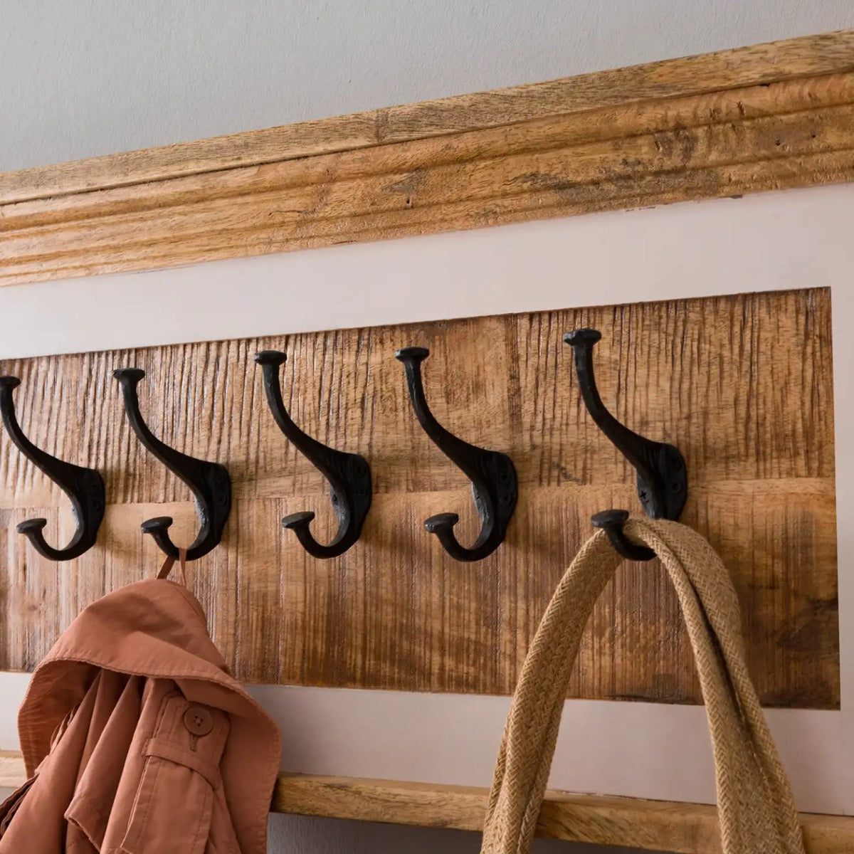 Handcrafted mango wood coat hanger with a whiteish finish