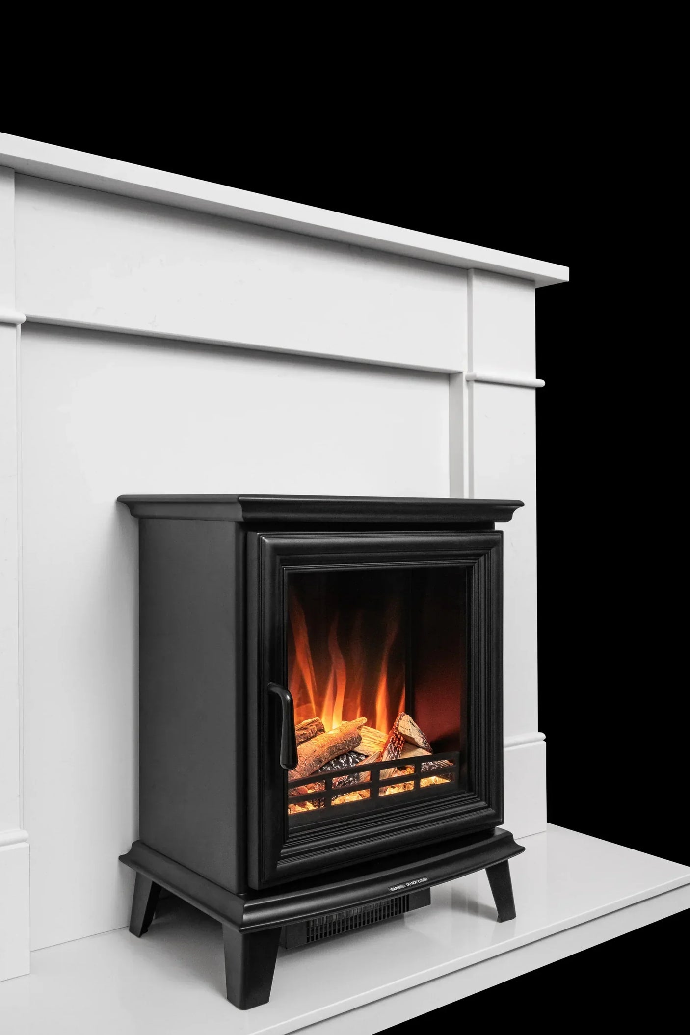 Black electric stove fireplace with realistic flame effect on white surround