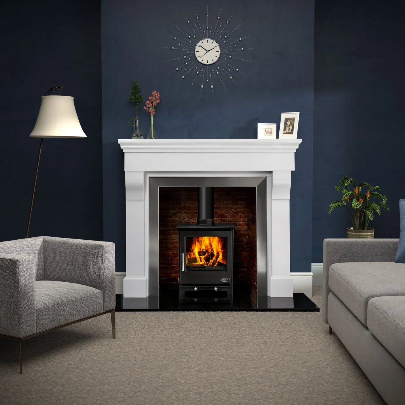 Modern living room with grey sofa, armchair, wood burning stove, and white fireplace