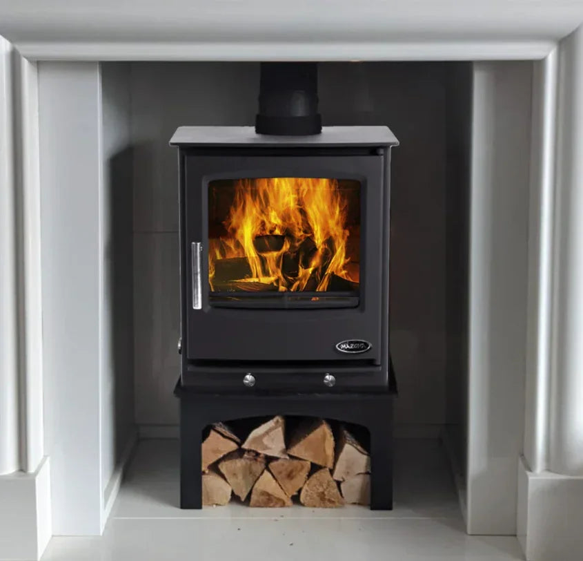 wood burning stove with visible fire and log store under black metal body