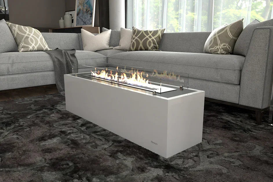 Rectangular white gas fire pit table with glass surround in modern living room with grey sofa