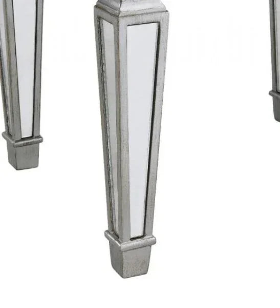 Mirrored furniture legs with silver trim and geometric design
