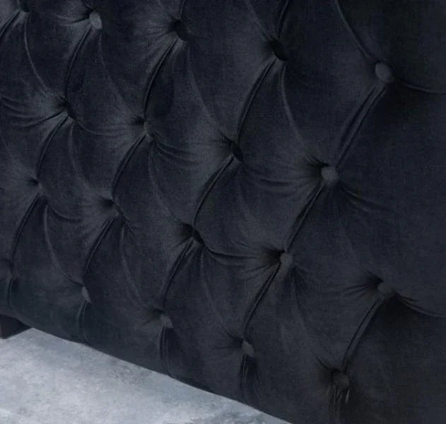 Black velvet upholstered headboard with deep button tufting detail