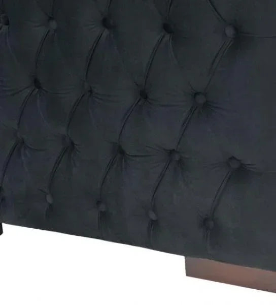 Black velvet upholstered bed frame with deep button tufted design