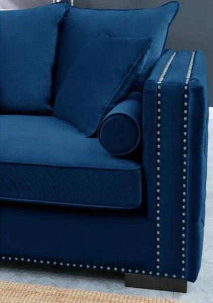 Blue velvet sofa with studded armrest and matching scatter cushions