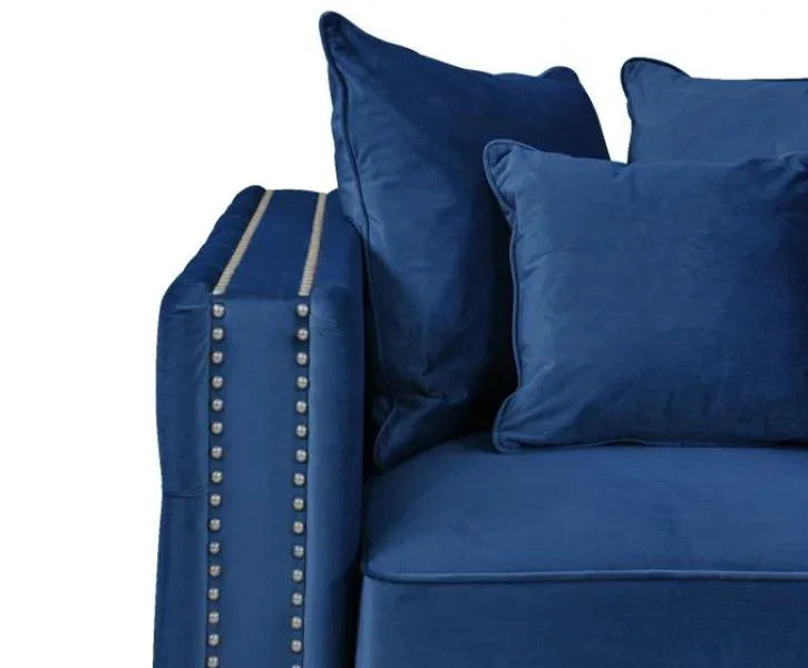 Blue velvet sofa with silver studded armrest and matching scatter cushions