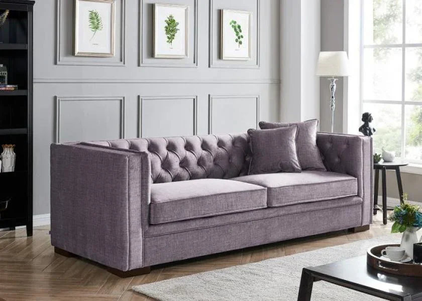 Grey fabric sofa with button-tufted backrest in modern living room setting