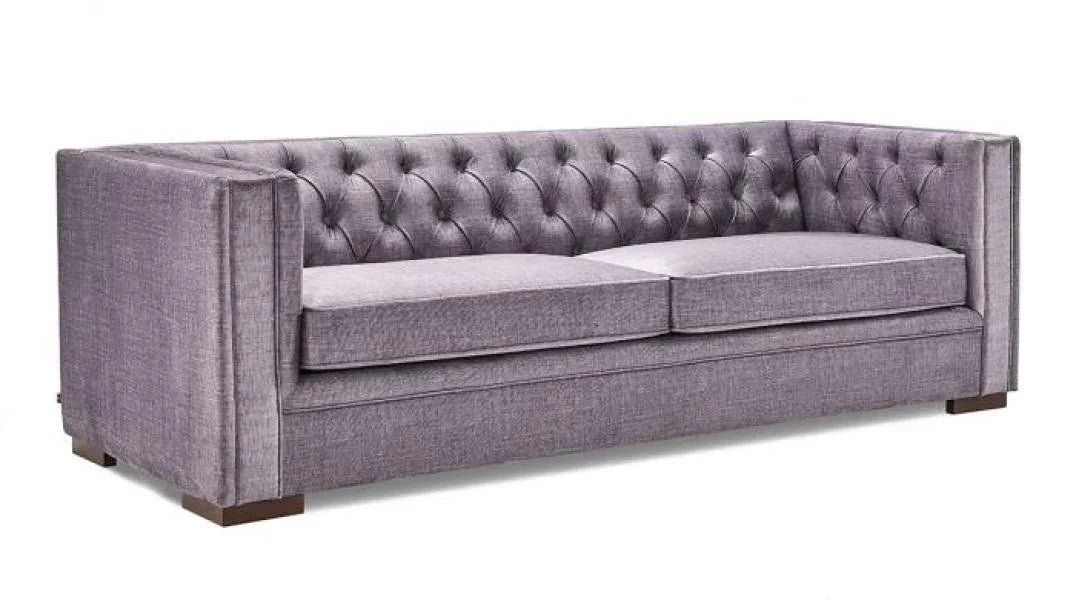 Grey fabric sofa with button-tufted backrest and wooden legs