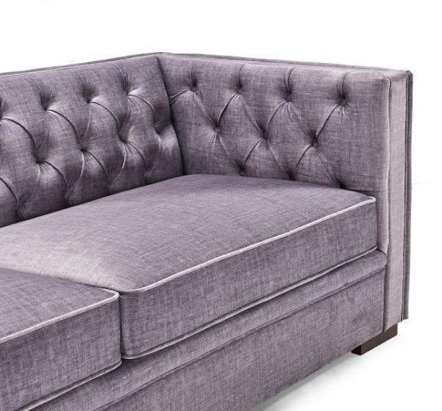 Grey fabric corner sofa with tufted backrest and seat cushions