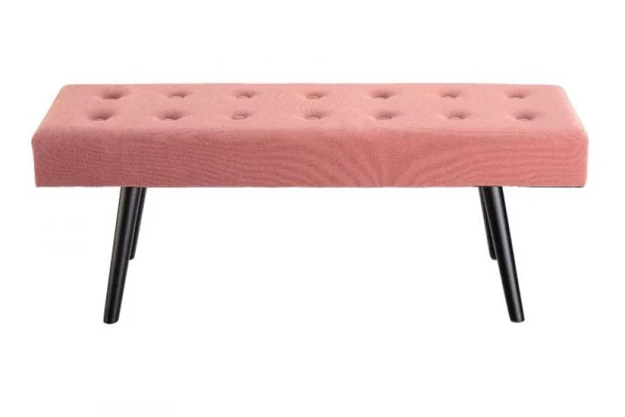 Pink upholstered bench with button-tufted seat and black angled legs