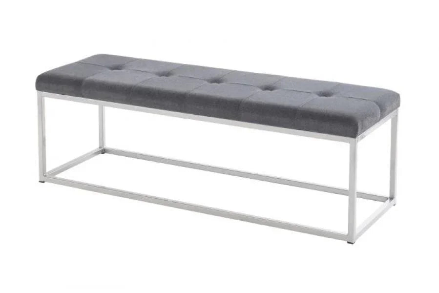Grey upholstered bench with tufted seat and silver metal frame