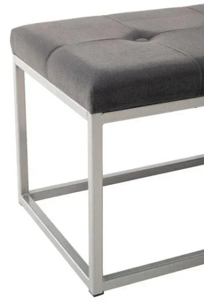 Grey fabric bench with metal frame and button-tufted seat, corner angle view