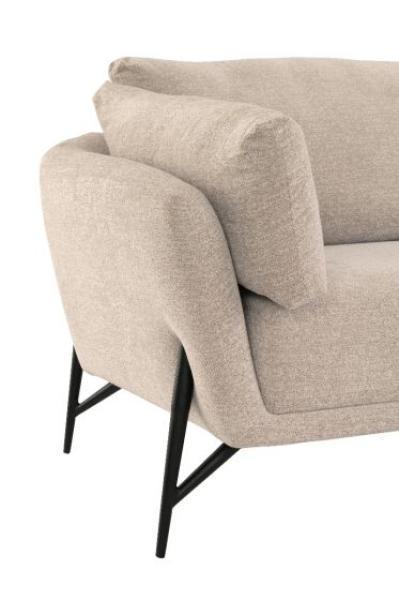 Beige fabric sofa corner with angled black metal legs and plush armrest