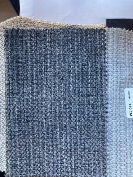 Grey woven upholstery fabric swatch with label showing texture and material detail