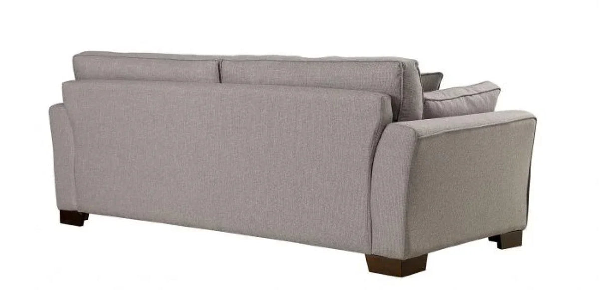 Light grey fabric sofa back view with wooden legs and padded armrests