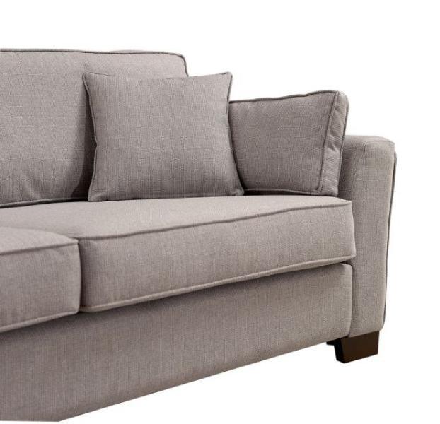 Light grey fabric sofa with firm cushions and wooden legs, right armrest view