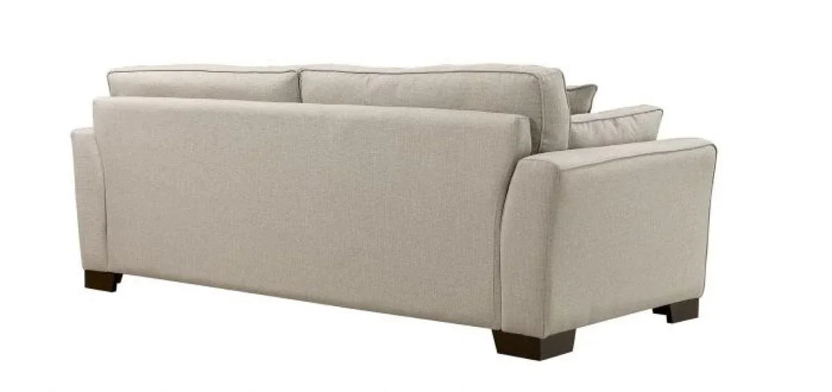 Beige fabric sofa with square arms and dark wood legs rear view