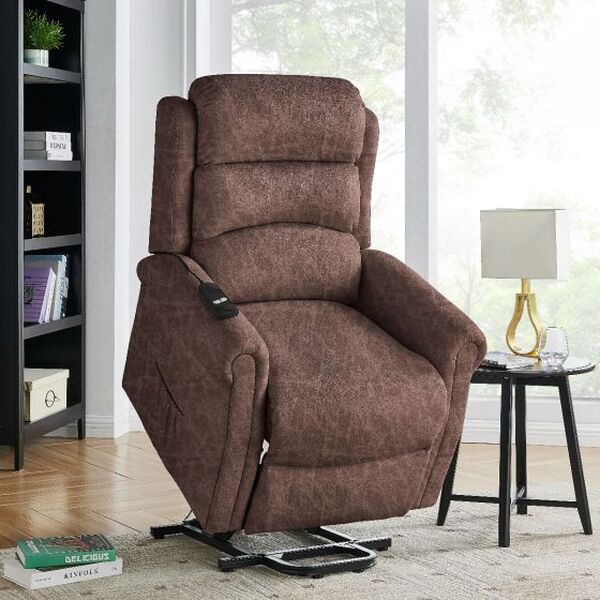 Brown fabric recliner chair with remote control in living room next to side table and lamp