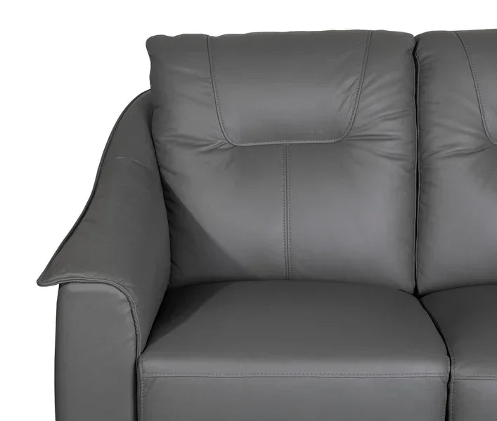 Close view of grey leather sofa armrest and plush back cushion