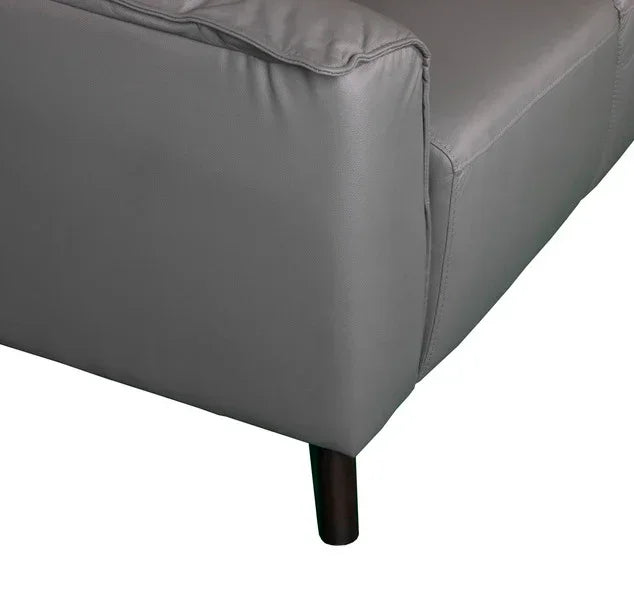 Grey leather sofa armrest and cushion with wooden leg close-up