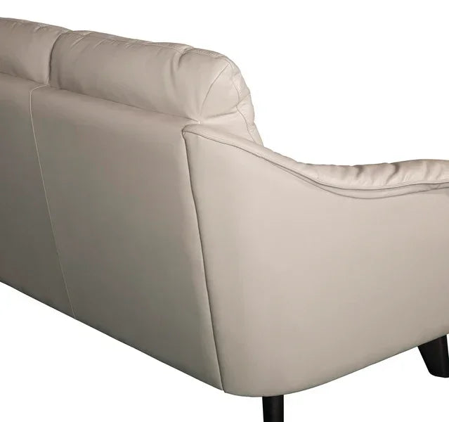 Rear view of cream leather sofa with black legs and cushioned backrest