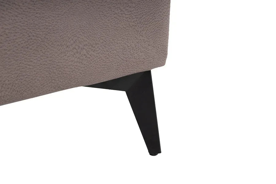 Closeup of fabric sofa corner with black metal leg furniture detail