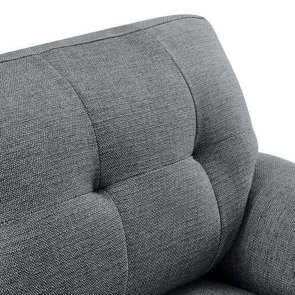 Close up of grey fabric sofa backrest with tufted cushion detail