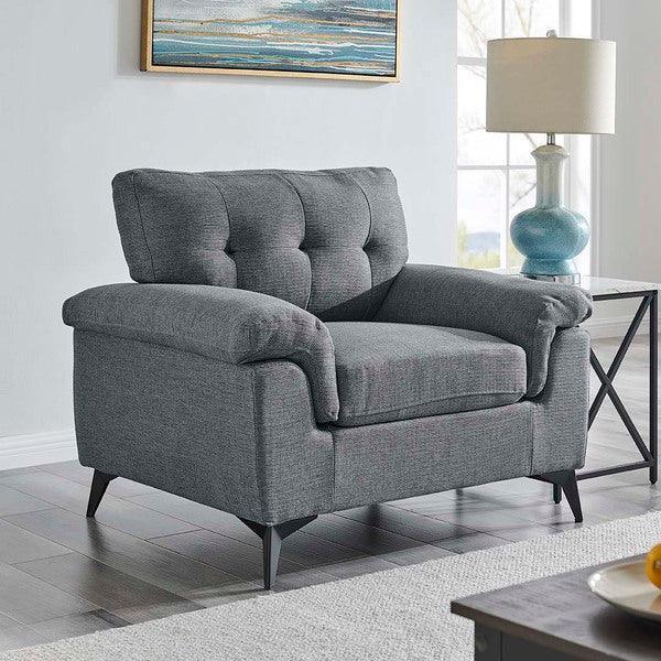 Grey fabric armchair with tufted back cushion and angled wooden legs in modern living room