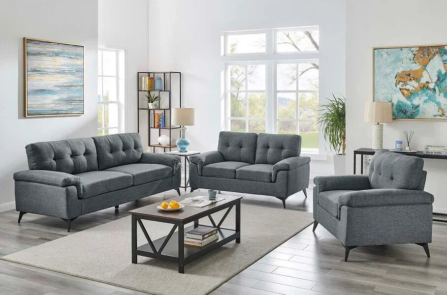 Grey fabric sofa set with armchair in modern living room with coffee table and large windows