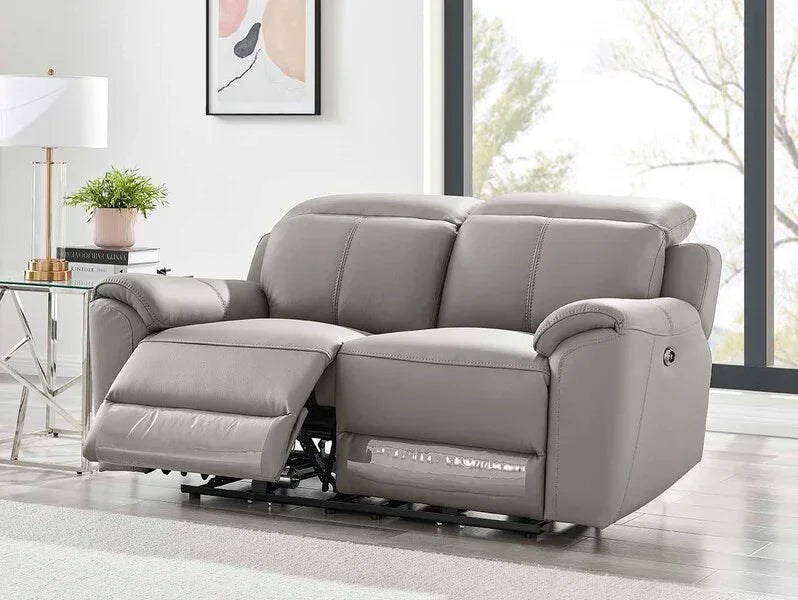 Light grey leather recliner sofa with footrest extended in modern living room