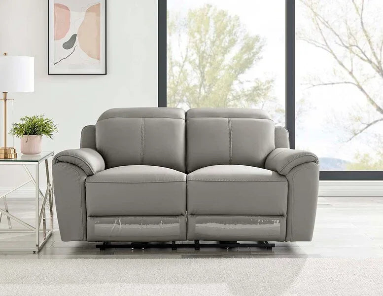 Grey leather reclining sofa in modern living room with large windows and side table