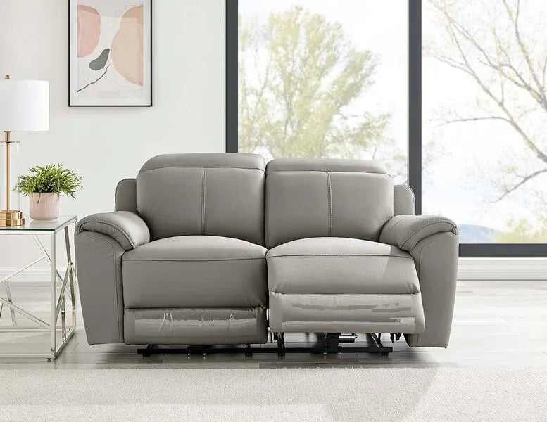 Grey leather reclining sofa in modern living room with large windows