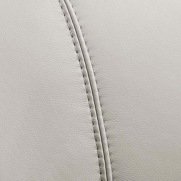 Closeup of light grey leather sofa upholstery with visible stitching detail