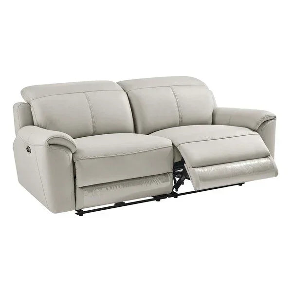 Light grey leather reclining sofa with extended footrest, angled front view