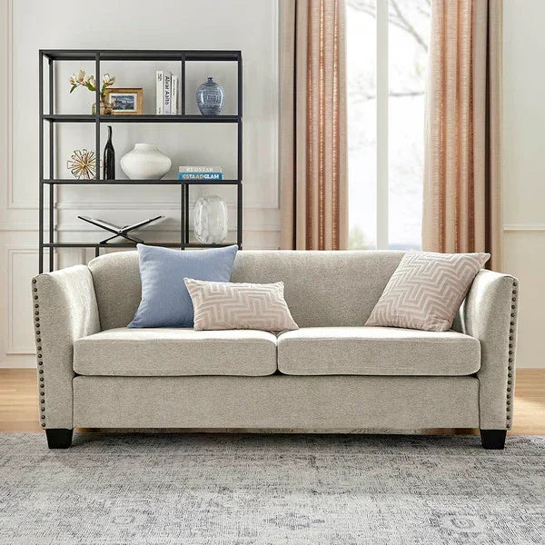 Light grey fabric sofa with accent cushions in a modern living room setting