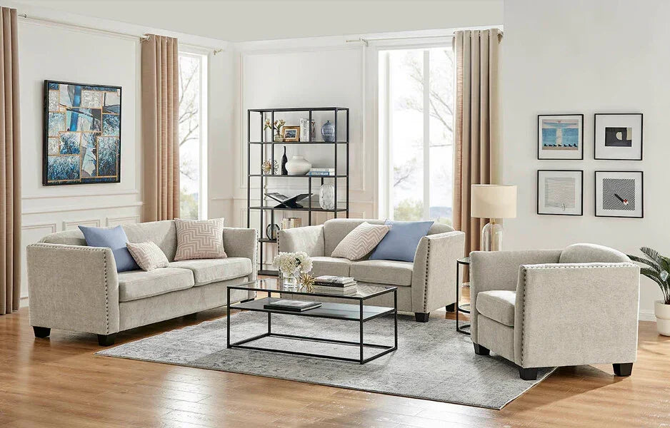 Light grey fabric sofa set with cushions and glass coffee table in modern living room