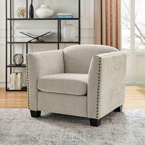 Light grey fabric armchair with nailhead trim and dark wood legs in living room setting