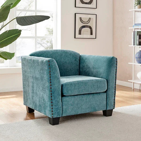 Teal fabric armchair with nailhead trim and black legs in modern living room